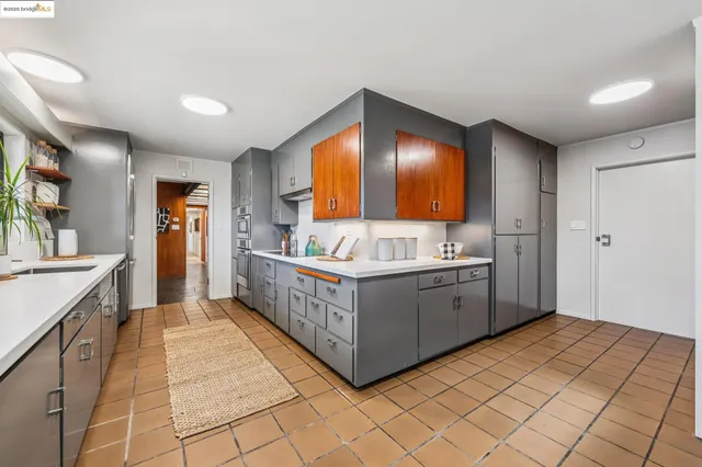a kitchen with granite countertop a sink and a stove