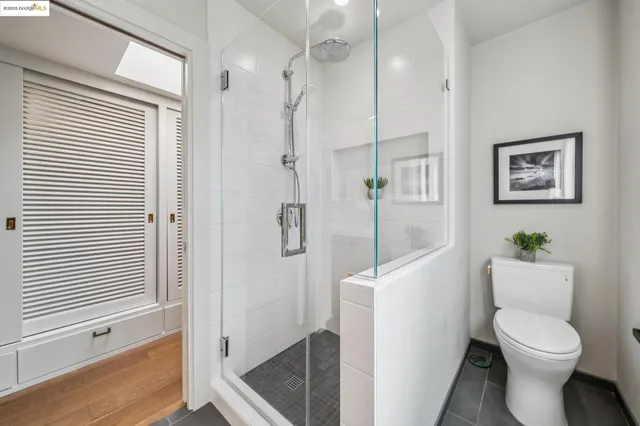 a bedroom with two beds and a large window