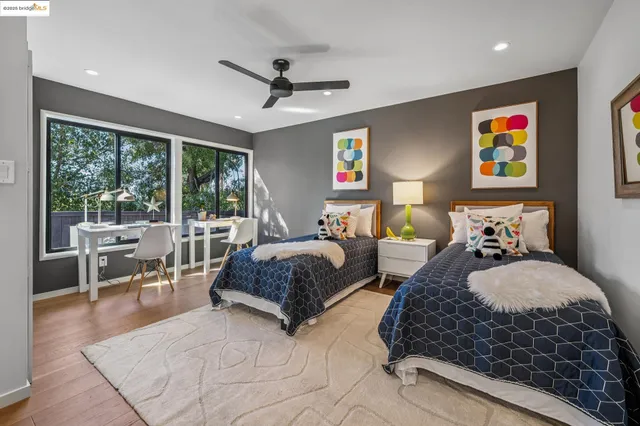 a bedroom with furniture and large windows