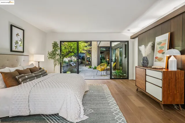 a bedroom with a bed and a large window