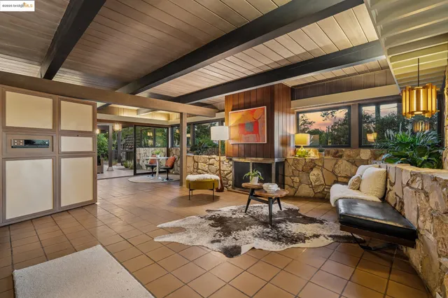 a view of a patio with dining table and chairs