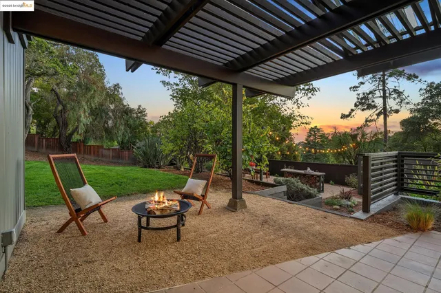 a view of a backyard with sitting area