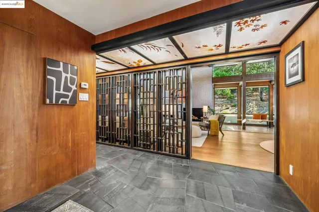 a living room with fireplace furniture and a large window
