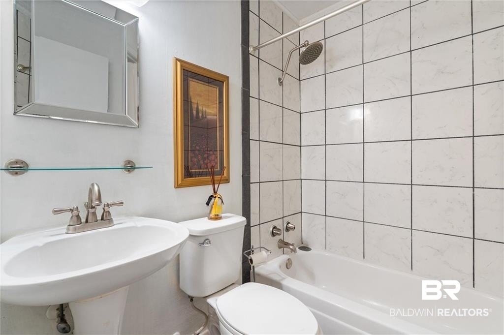 218 Grand Boulevard Mobile, AL 36607 - Photo 4 of 22 Full bathroom with toilet, tiled shower / bath, and sink