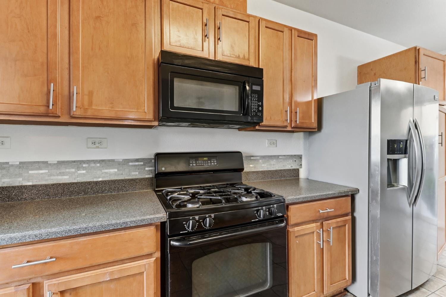 11832 Stoney Ridge Way Rancho Cordova, CA 95742 - Photo 11 of 44 a kitchen with stainless steel appliances granite countertop white cabinets a stove top oven