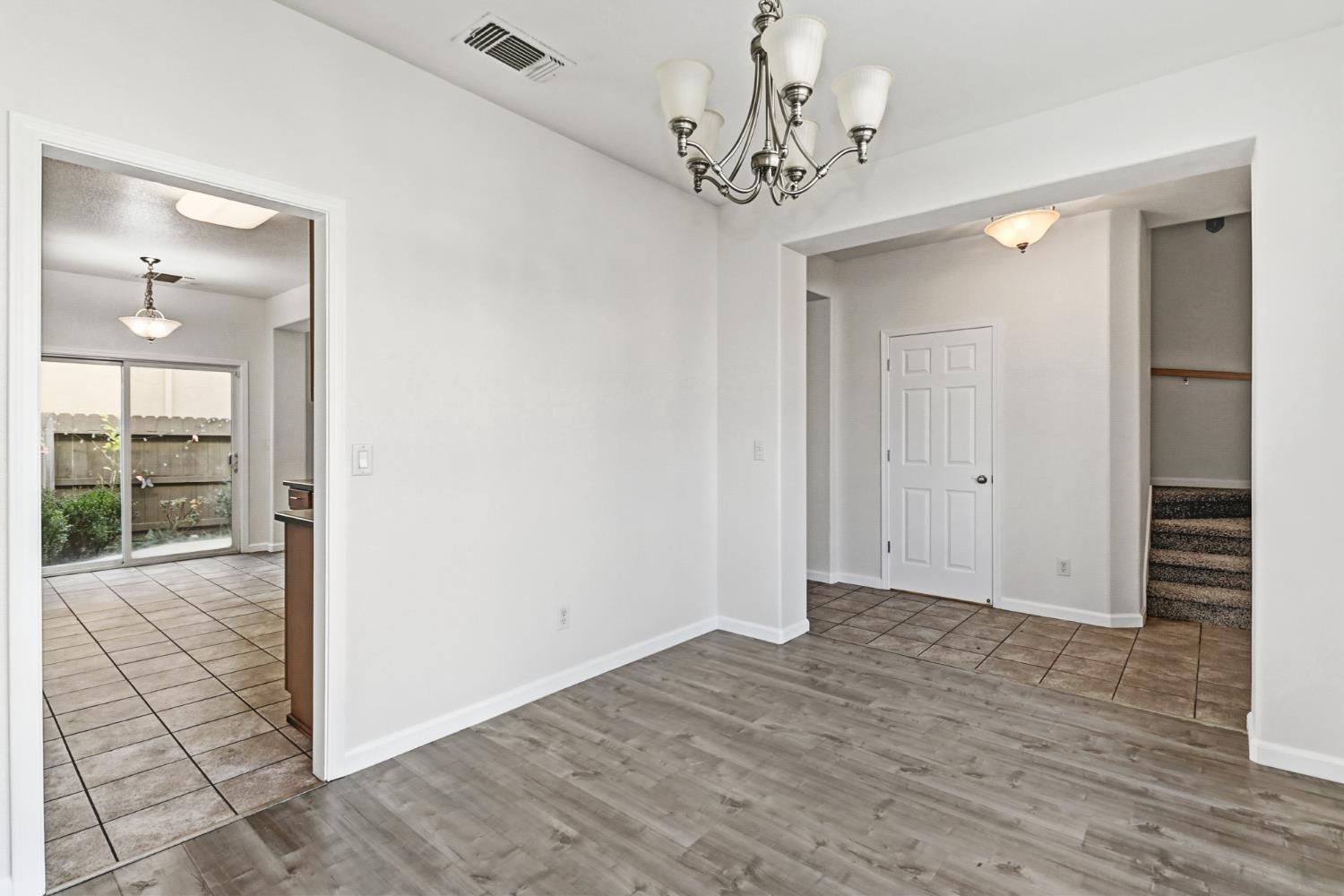 11832 Stoney Ridge Way Rancho Cordova, CA 95742 - Photo 15 of 44 a view of a hallway with wooden floor and a chandelier