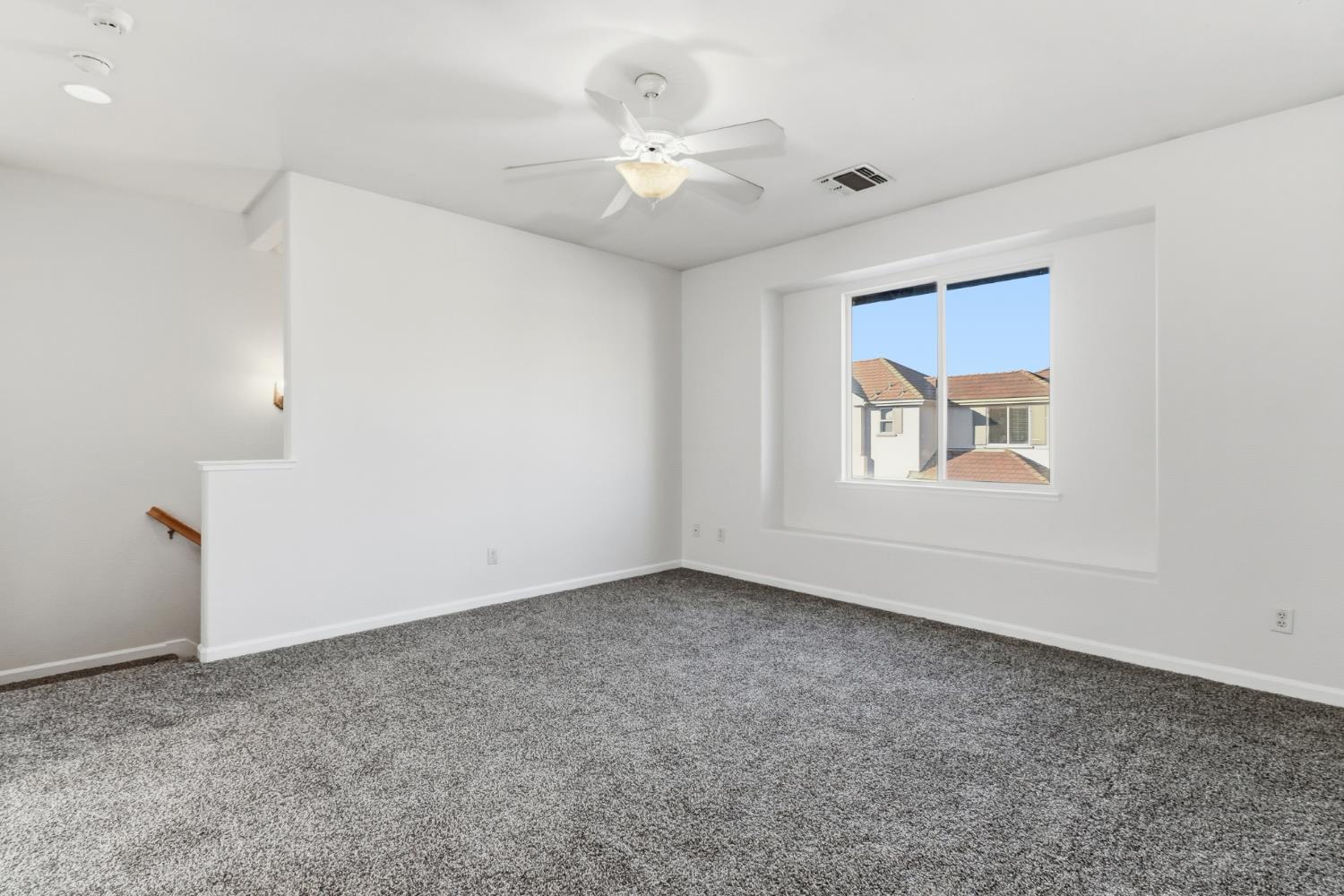 11832 Stoney Ridge Way Rancho Cordova, CA 95742 - Photo 17 of 44 an empty room with windows and ceiling fan