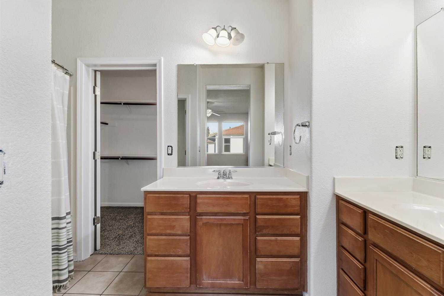 11832 Stoney Ridge Way Rancho Cordova, CA 95742 - Photo 24 of 44 a room that has a sink and a mirror in it