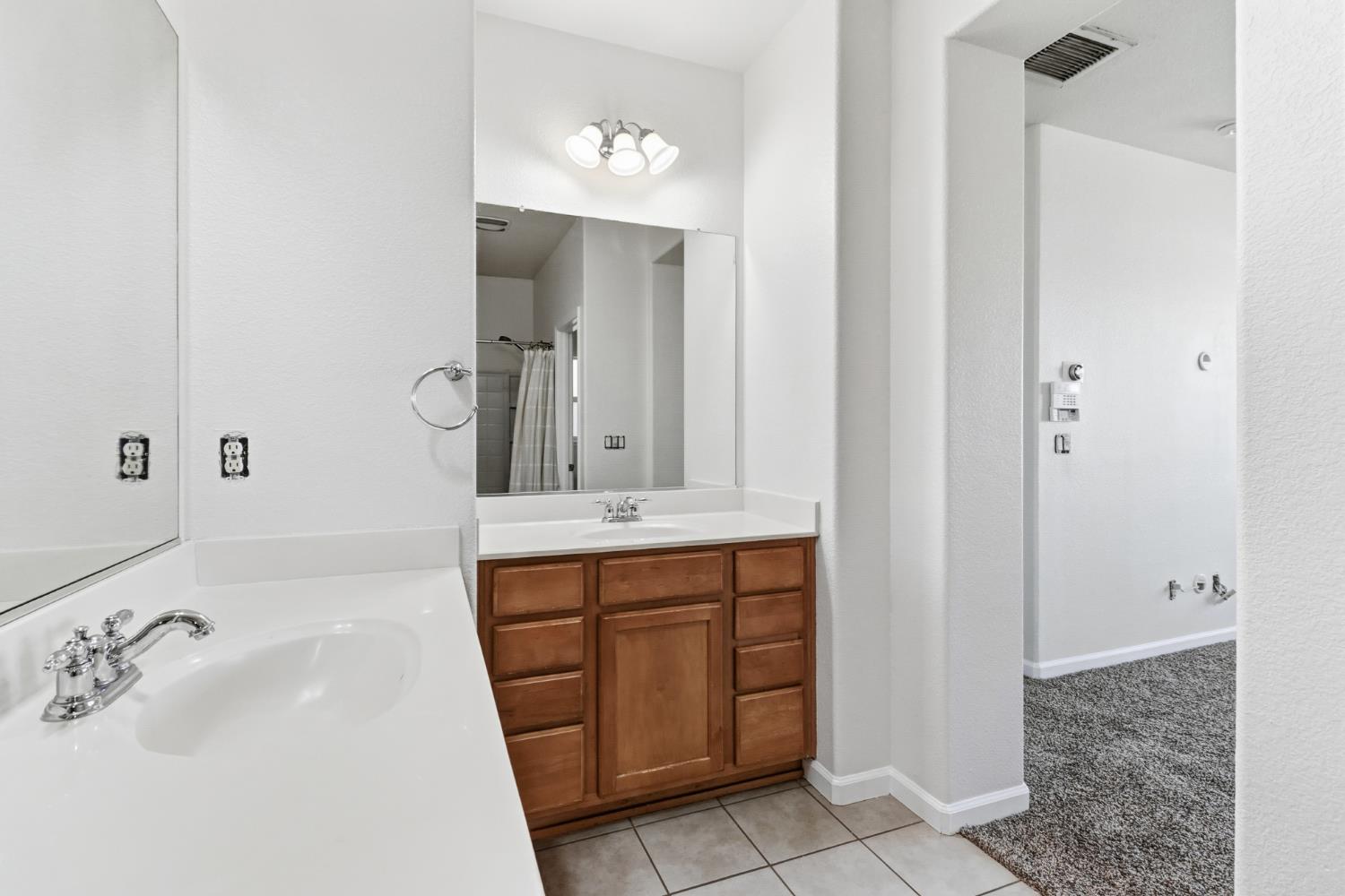 11832 Stoney Ridge Way Rancho Cordova, CA 95742 - Photo 25 of 44 a bathroom with a sink and a mirror