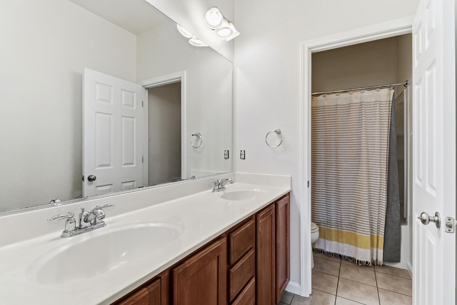 11832 Stoney Ridge Way Rancho Cordova, CA 95742 - Photo 33 of 44 a bathroom with a sink vanity and a mirror