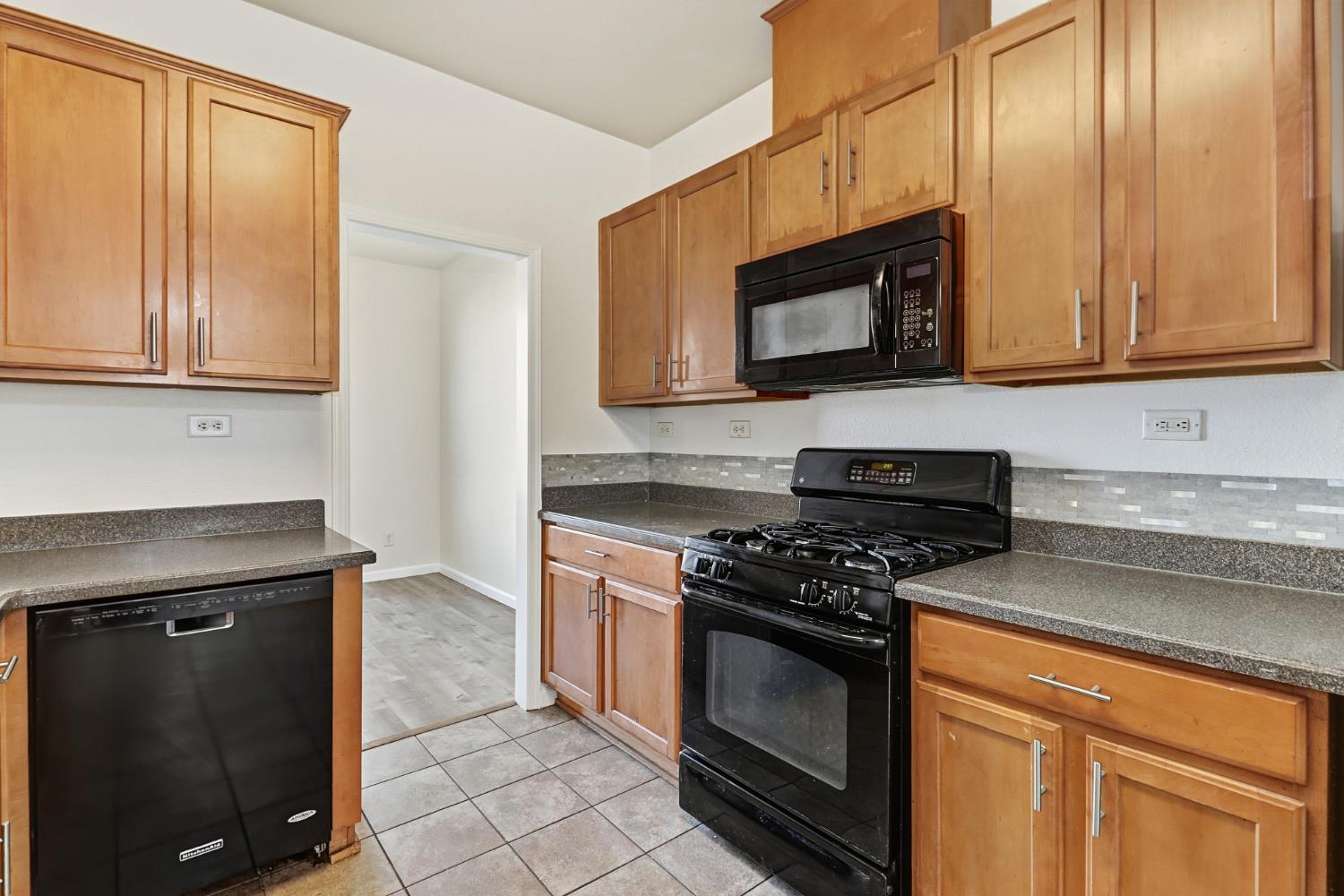11832 Stoney Ridge Way Rancho Cordova, CA 95742 - Photo 10 of 44 a kitchen with stainless steel appliances granite countertop a stove microwave and sink