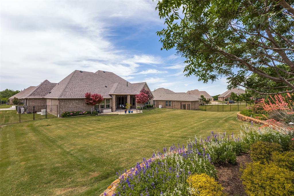 506 Life Spring Drive Rockwall, TX 75087 - Photo 34 of 36 a view of a house with a big yard next to a large tree