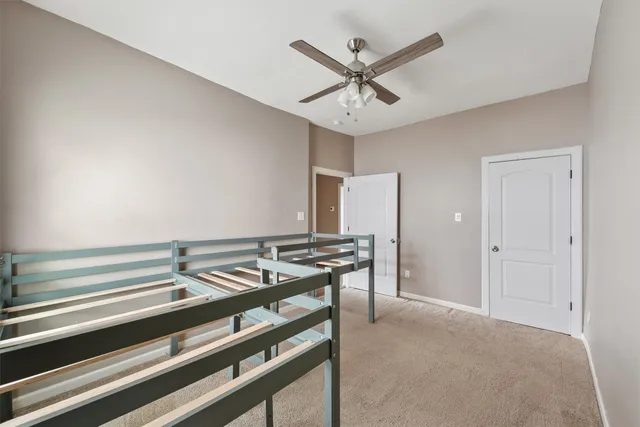 a view of a hallway with a ceiling fan