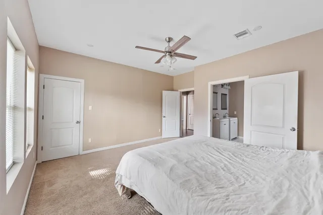 a bedroom with a large bed and a chandelier
