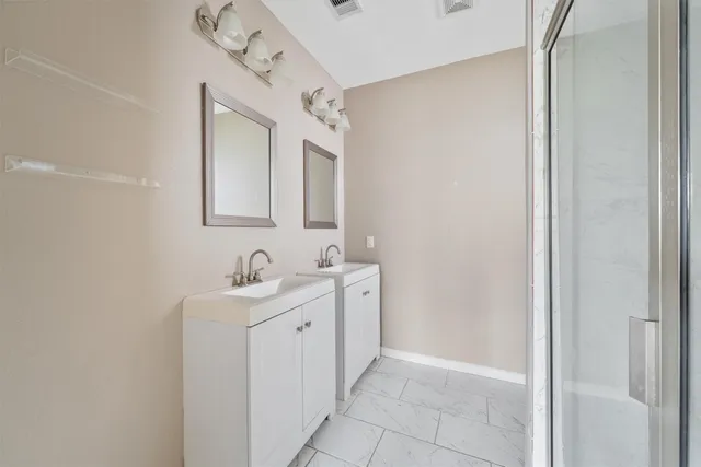 a bathroom with a double vanity sink and mirror