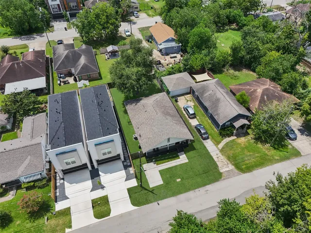 an aerial view of multiple houses with yard