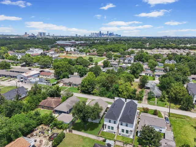 an aerial view of multiple houses with a yard