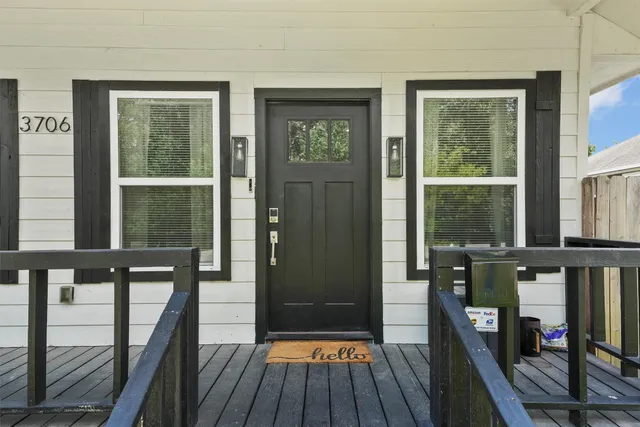 a view of a balcony with wooden floor and furniture