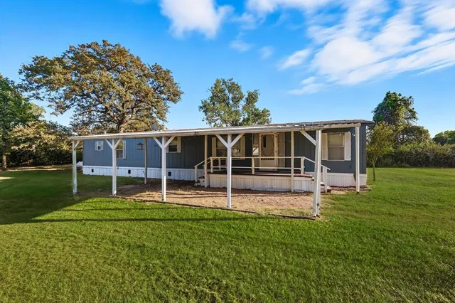 a house view with a sitting space and garden