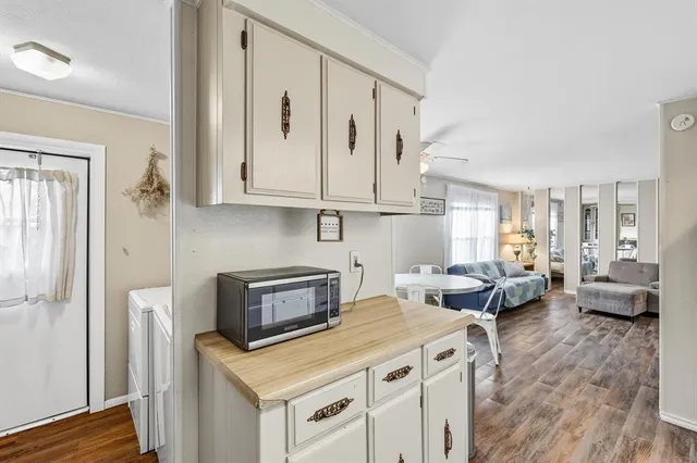 a view of kitchen with stainless steel appliances granite countertop a stove and a refrigerator