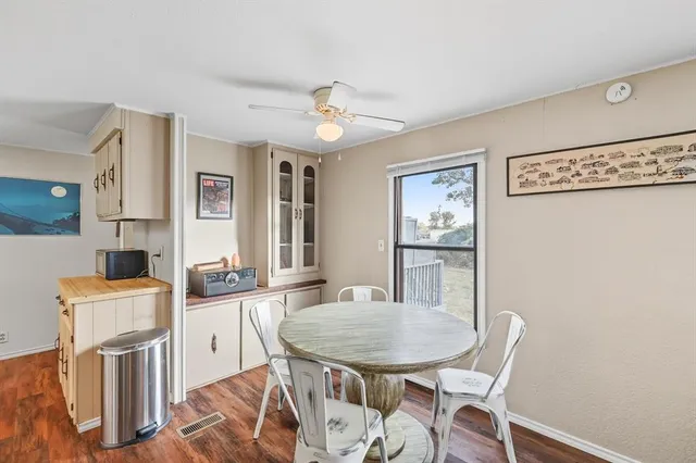 a view of a dining room with furniture and a chandelier