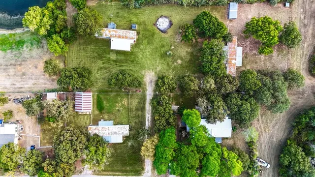 an aerial view of a house with a yard and garden