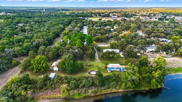an aerial view of a house with a yard