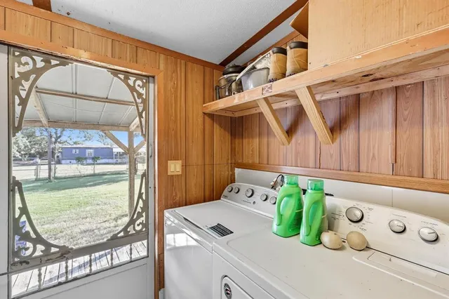 a view of washer and dryer with a livingroom