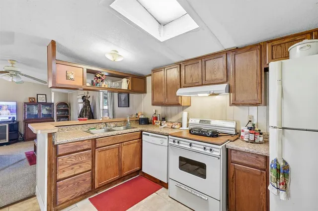 a kitchen with a stove sink and refrigerator