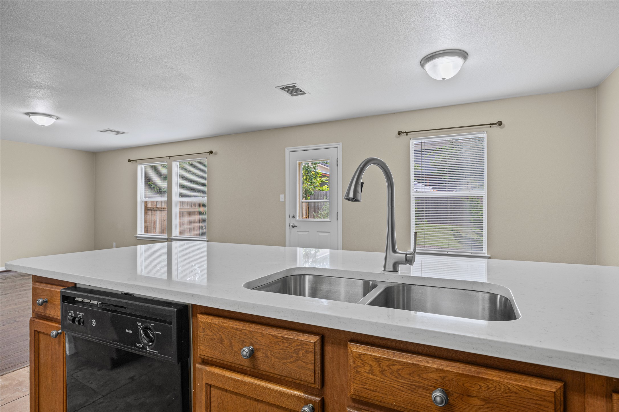 198 Black Forest Road Buda, TX 78610 - Photo 7 of 23 A spacious kitchen with a modern double-basin sink and a sleek faucet, perfect for entertaining.