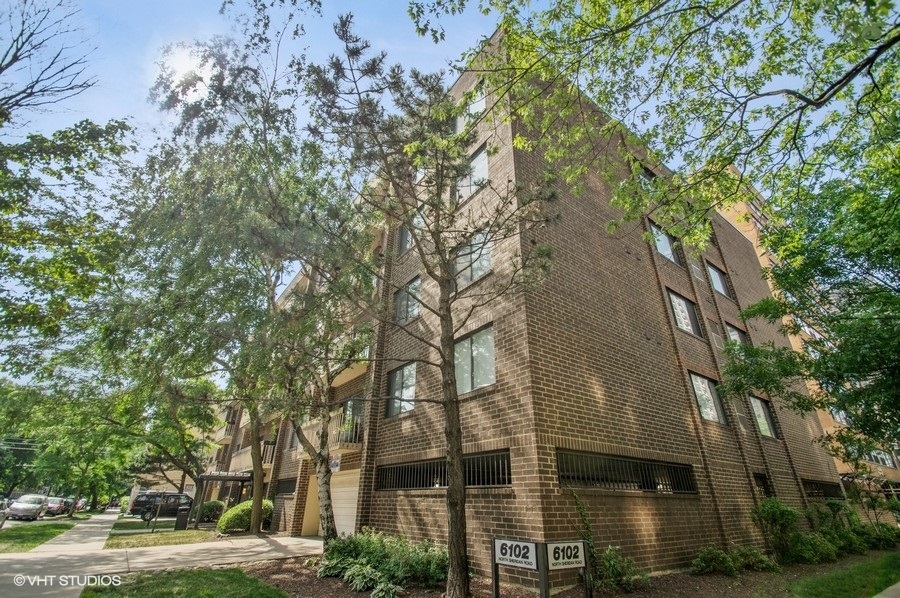 6102 North Sheridan Road, Unit 410 Chicago, IL 60660 - Photo 1 of 12 front view of a building with a trees