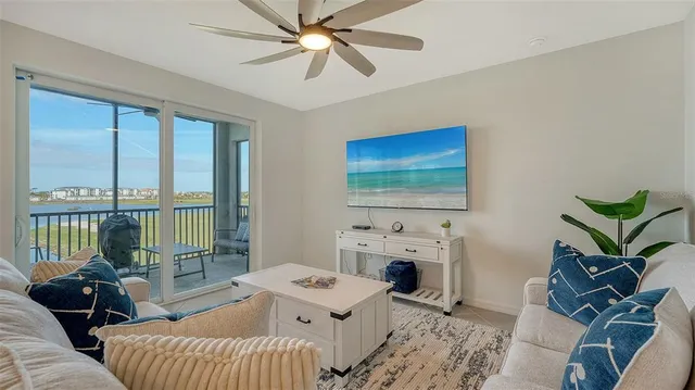 a kitchen with stainless steel appliances granite countertop a dining table chairs refrigerator and cabinets