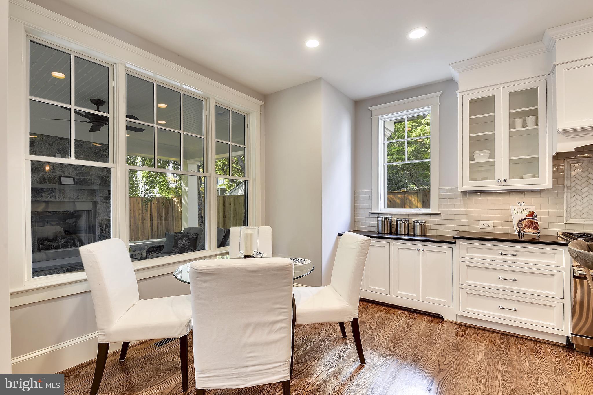 7810 Custer Road Bethesda, MD 20814 - Photo 7 of 30 a dining room with wooden floor and windows