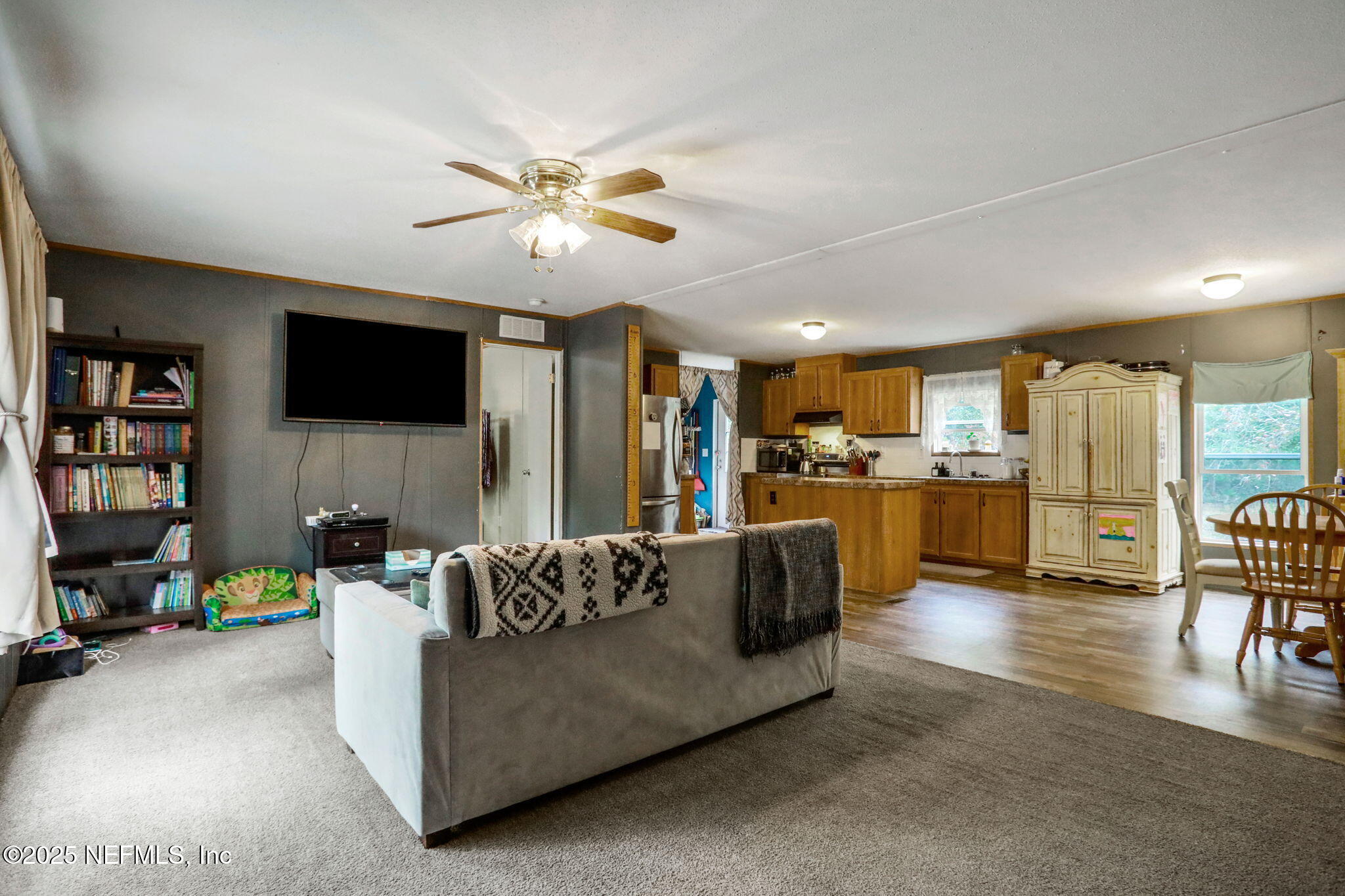 4527 Bondarenko Road Keystone Heights, FL 32656 - Photo 11 of 56 a living room with furniture and a flat screen tv