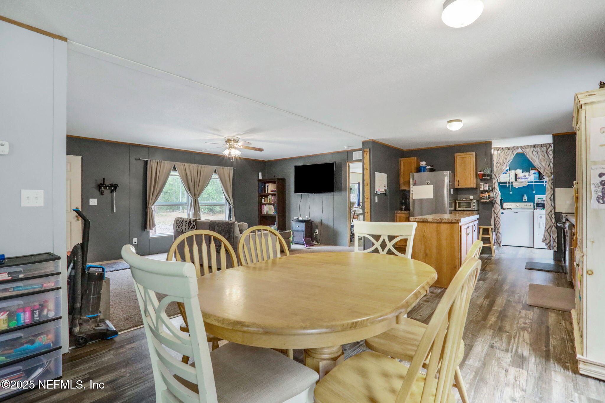 4527 Bondarenko Road Keystone Heights, FL 32656 - Photo 13 of 56 a dining room with furniture a rug and wooden floor
