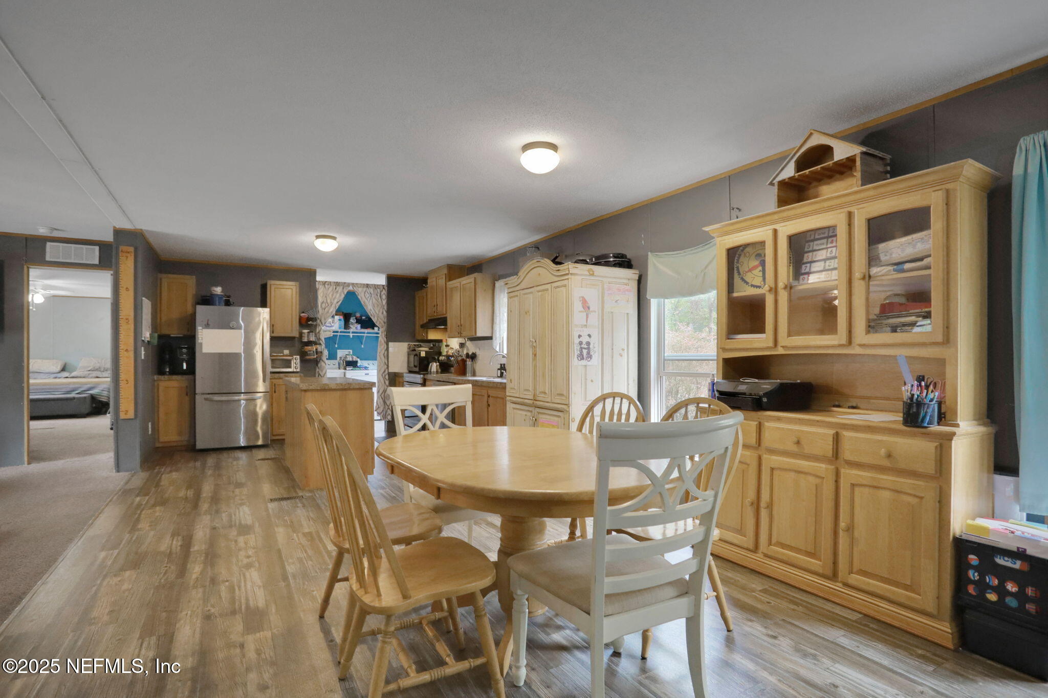 4527 Bondarenko Road Keystone Heights, FL 32656 - Photo 14 of 56 a dining room with furniture and large windows