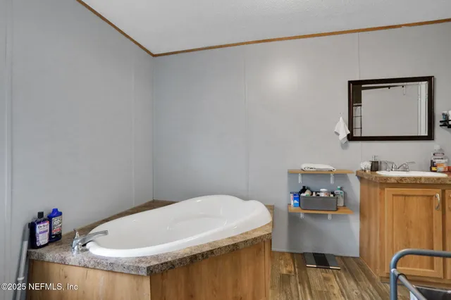 a kitchen with stainless steel appliances granite countertop a refrigerator stove and wooden floor