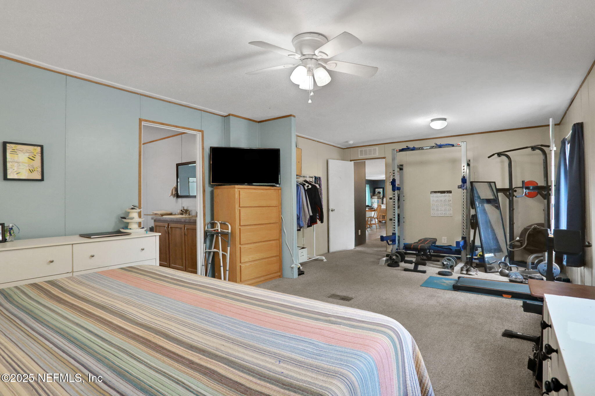 4527 Bondarenko Road Keystone Heights, FL 32656 - Photo 21 of 56 a bedroom with bed a flat tv screen and closet