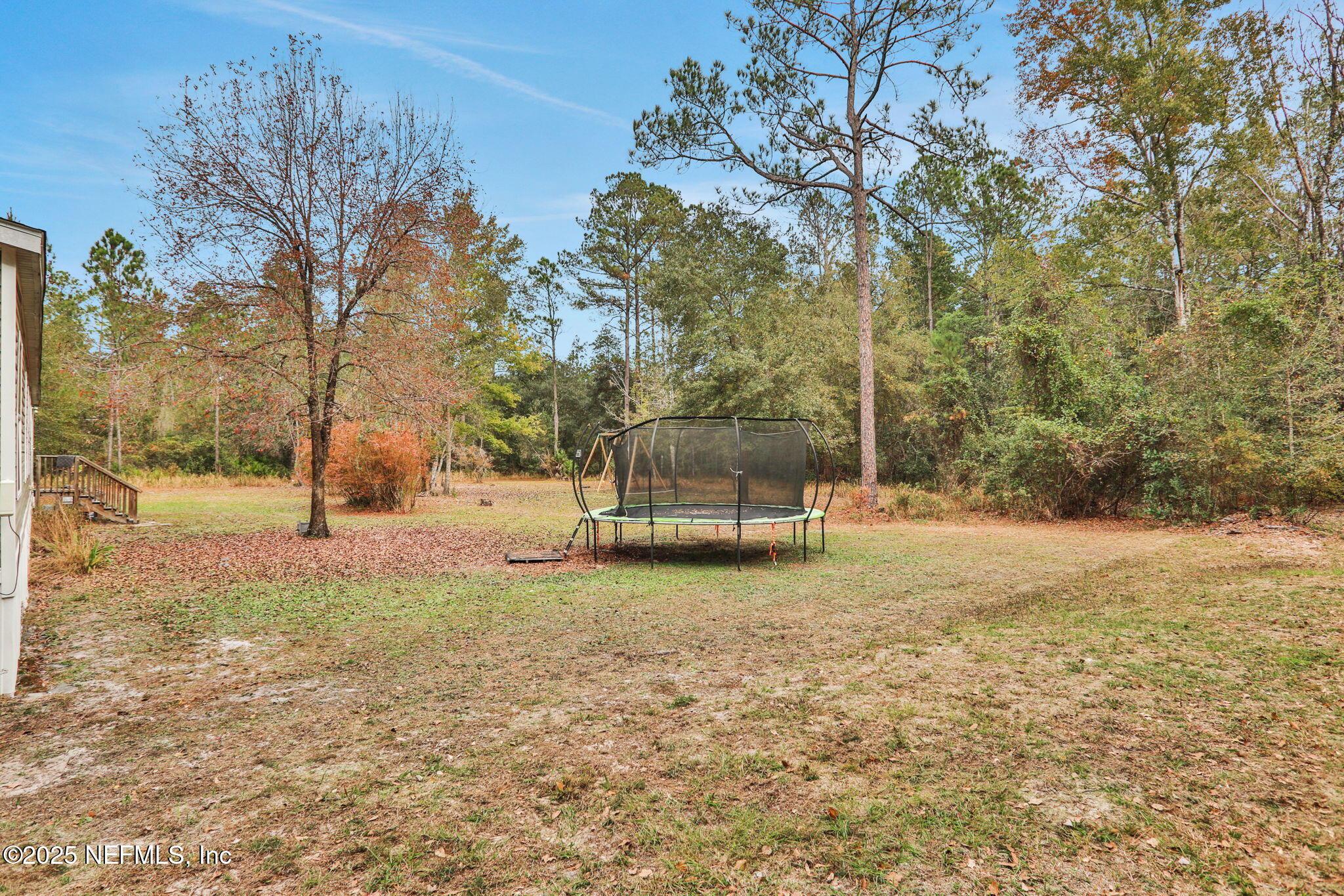 4527 Bondarenko Road Keystone Heights, FL 32656 - Photo 23 of 56 a backyard of a house with trees
