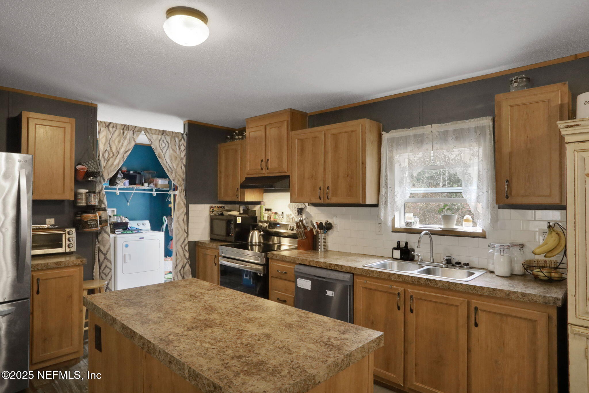 4527 Bondarenko Road Keystone Heights, FL 32656 - Photo 28 of 56 a kitchen with a sink stove and refrigerator