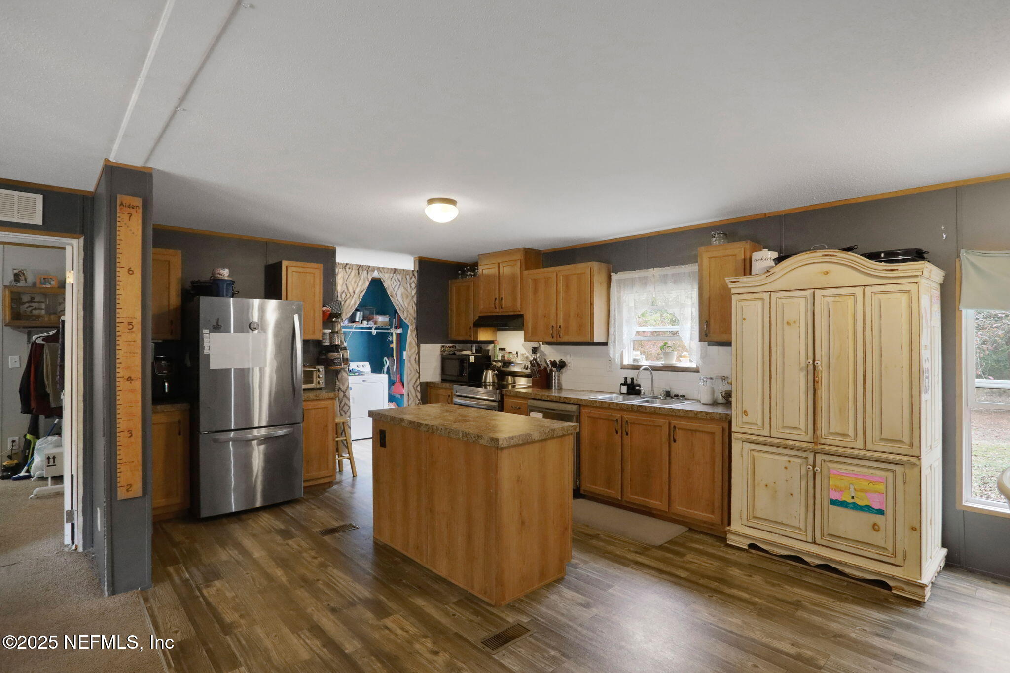 4527 Bondarenko Road Keystone Heights, FL 32656 - Photo 29 of 56 a kitchen with stainless steel appliances granite countertop a refrigerator stove and wooden floor