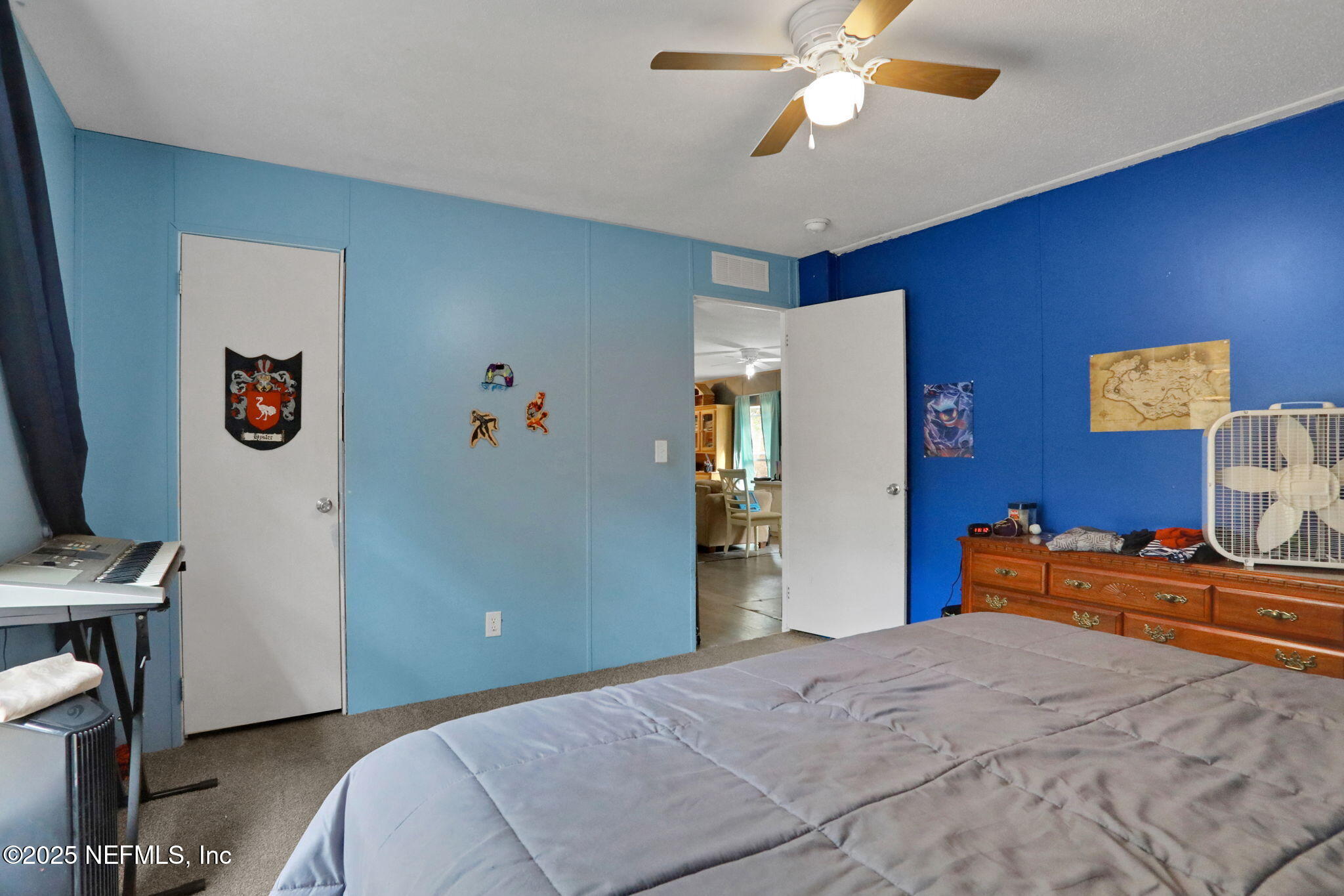 4527 Bondarenko Road Keystone Heights, FL 32656 - Photo 53 of 56 a bedroom with a bed and a chandelier