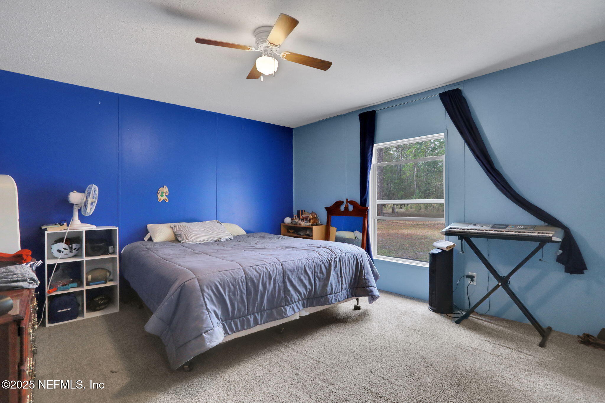 4527 Bondarenko Road Keystone Heights, FL 32656 - Photo 54 of 56 a bedroom with a bed a desk and chair