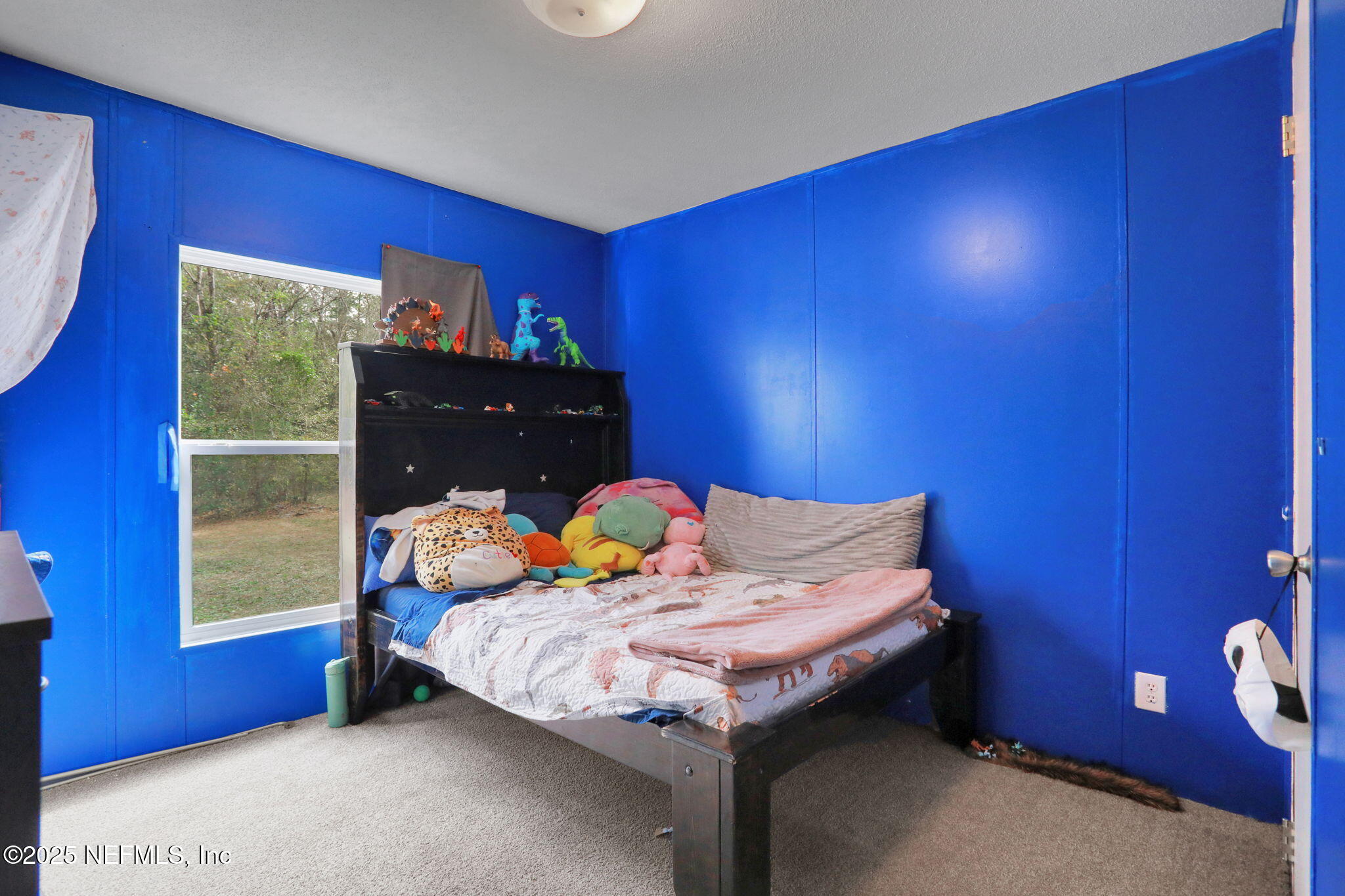 4527 Bondarenko Road Keystone Heights, FL 32656 - Photo 56 of 56 a bed sitting in a bedroom next to a window