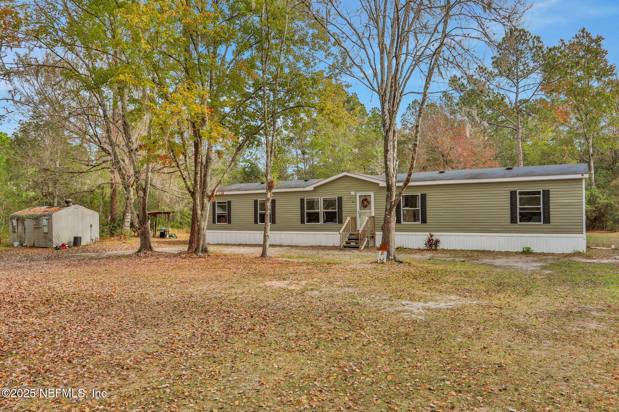 4527 Bondarenko Road Keystone Heights, FL 32656 - Photo 6 of 56 a house with trees in front of it