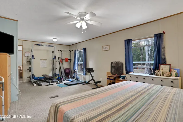 a dining room with furniture and large windows