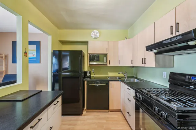a kitchen with a sink stove and refrigerator