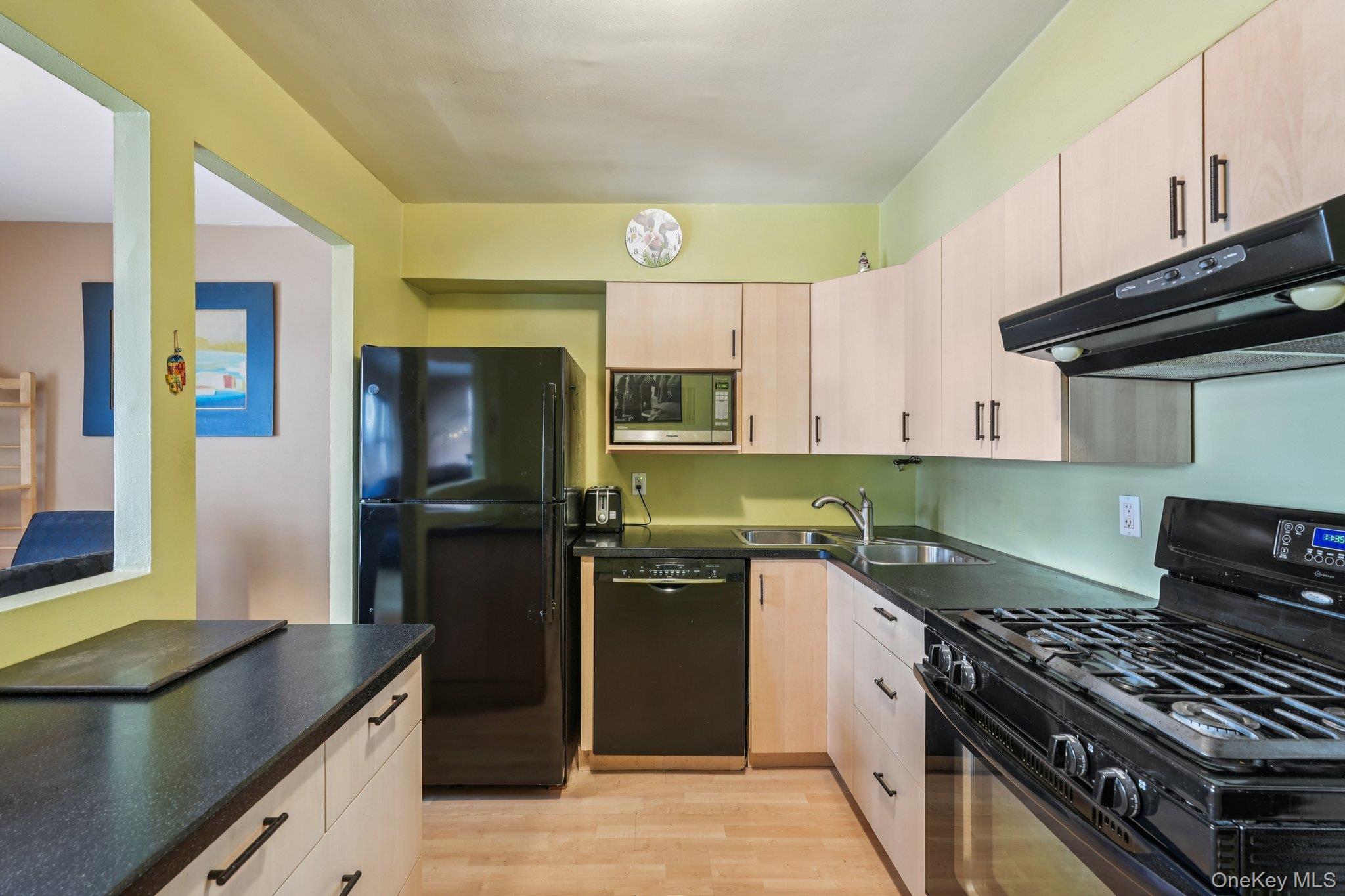 57 Maple Avenue, Unit 2B Hastings-on-Hudson, NY 10706 - Photo 12 of 38 a kitchen with a sink stove and refrigerator