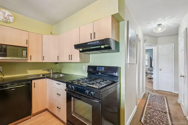 a kitchen with granite countertop a stove and a sink