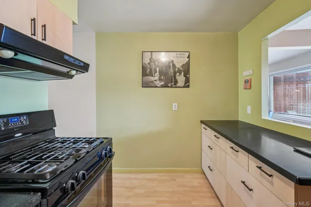 a kitchen with granite countertop a stove and a sink